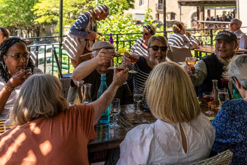 Happy travelers cheering at lunch