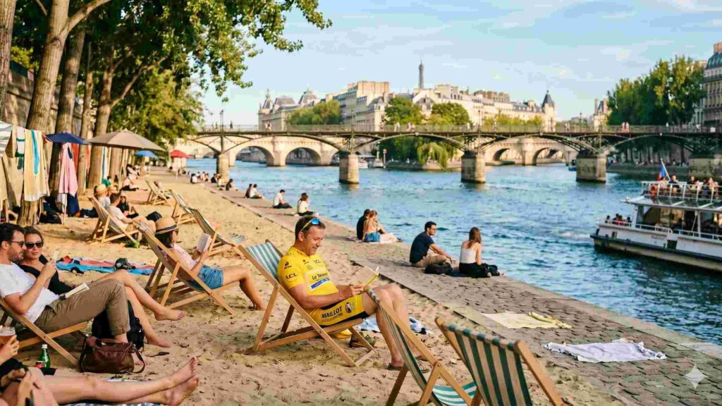 Sandy bank of river in Paris with people reading in lounge chairs
