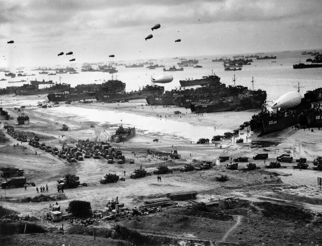 Allied forces unloading supplies and equipment from Landing Ship, Tanks (LSTs) on Omaha Beach during the Normandy landings (Operation Overlord)